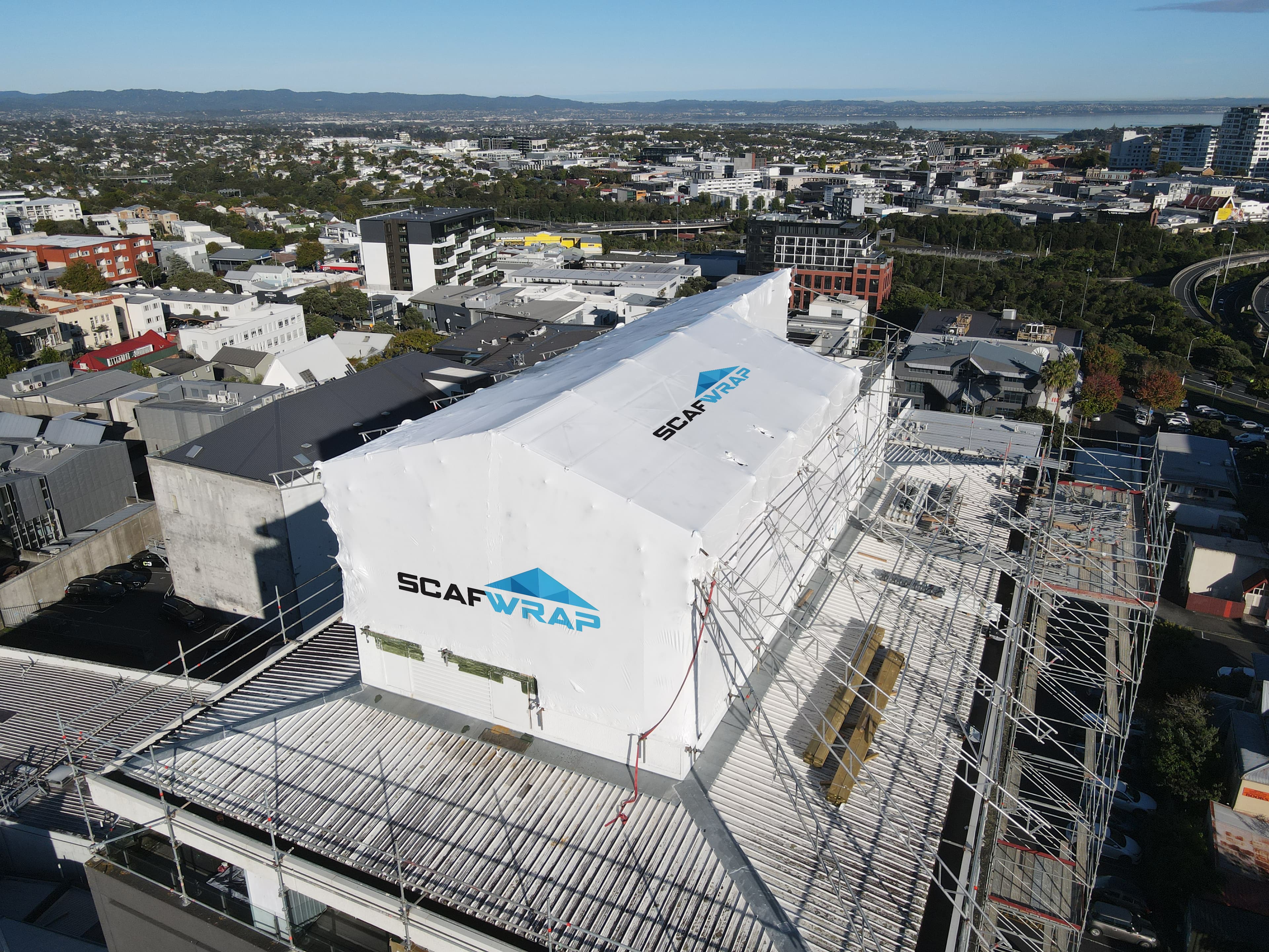 Shrink wrap weatherproofing on scaffolding at a construction site in Auckland, New Zealand