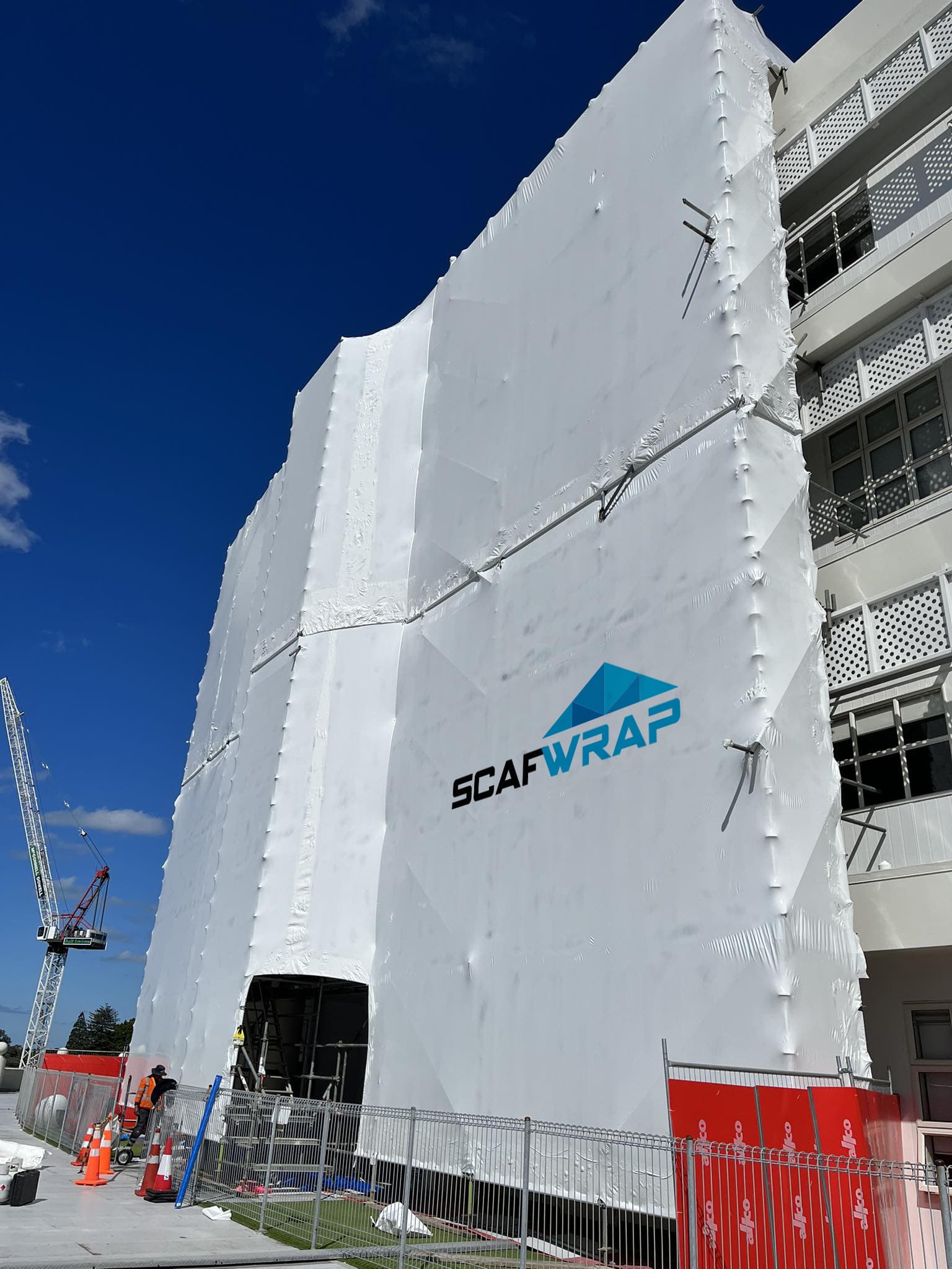 Residential building recladding project with weatherproof shrink wrap in Auckland