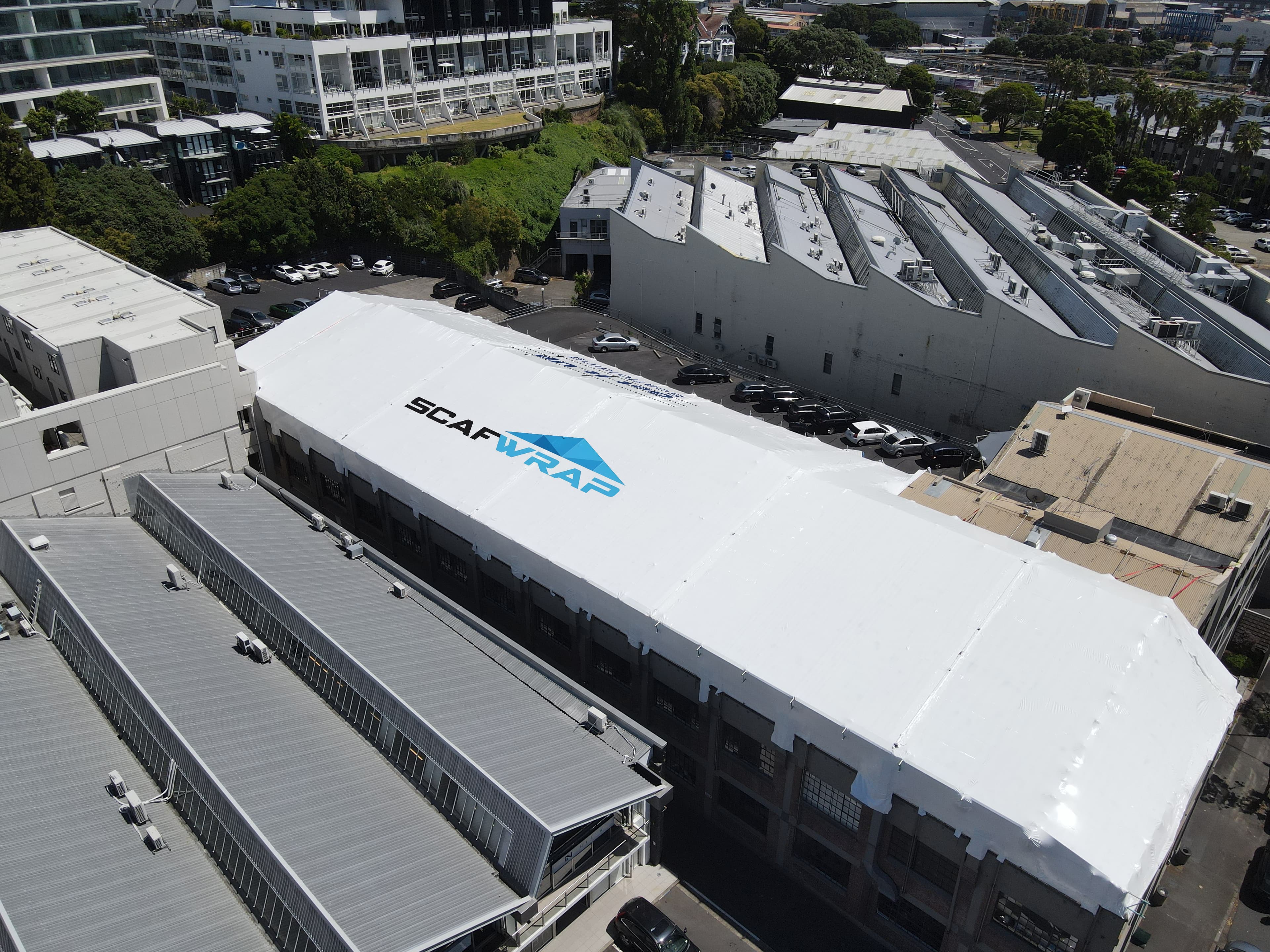 Residential building recladding project with weatherproof shrink wrap in Auckland