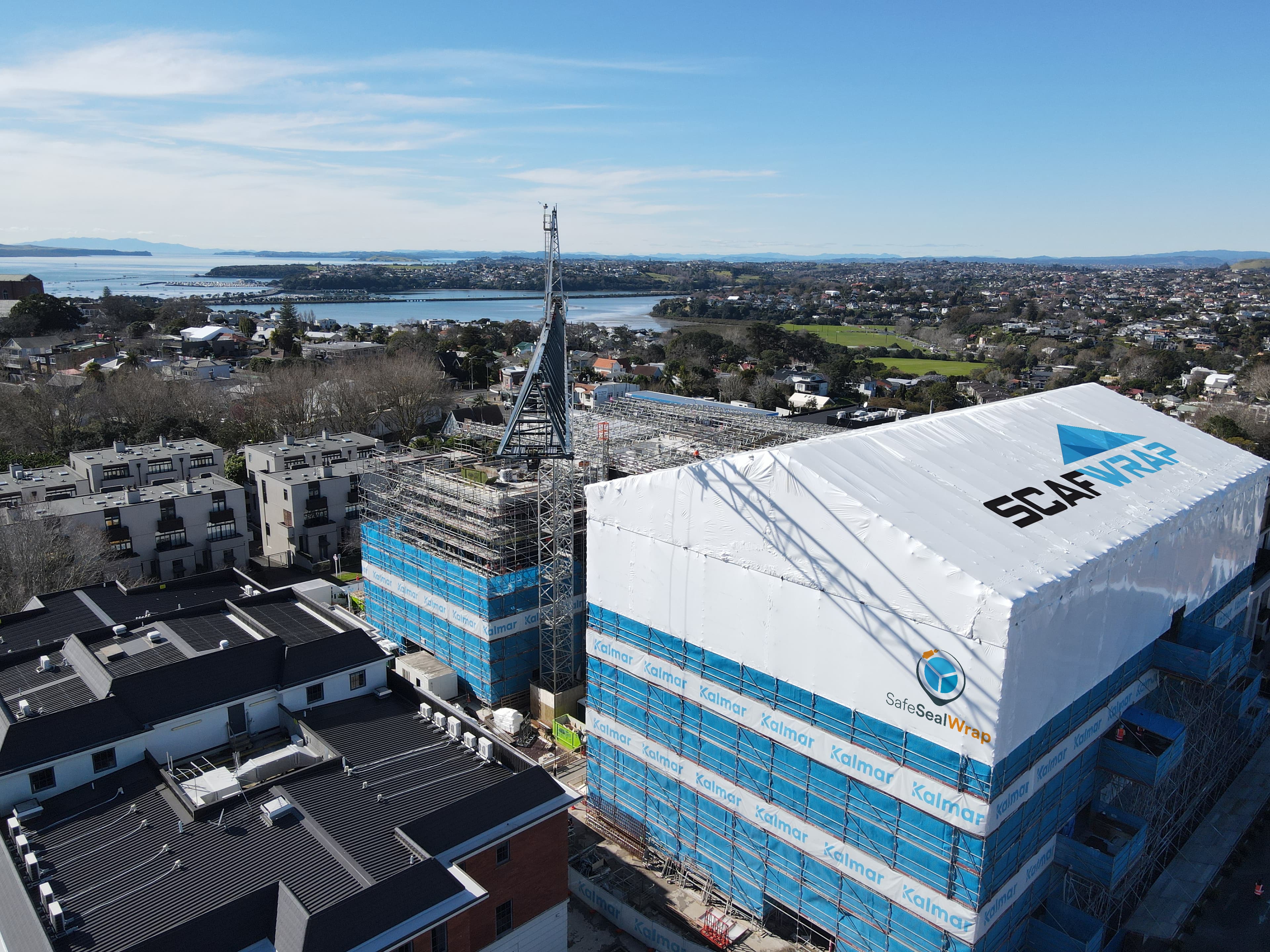 Residential building recladding project with weatherproof shrink wrap in Auckland